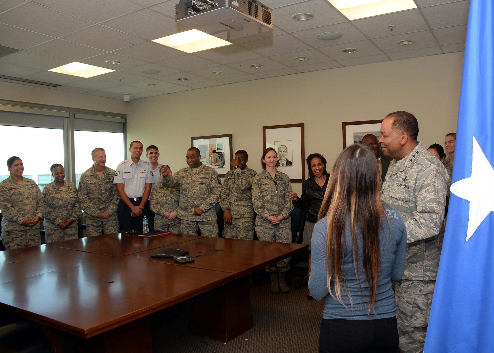 Lt. Gen. Samuel Greaves, Space and Missile Systems Center commander and Air Force program executive officer for space, shares a light moment with Air Force Reserve recruit Jennie Ines prior to beginning an impromptu oath of enlistment ceremony, Jan. 21, 2016. The event transpired as the result of a chance meeting the previous December by the Exchange at Los Angeles Air Force Base in El Segundo, Calif. (U.S. Air Force photo/Van Ha)