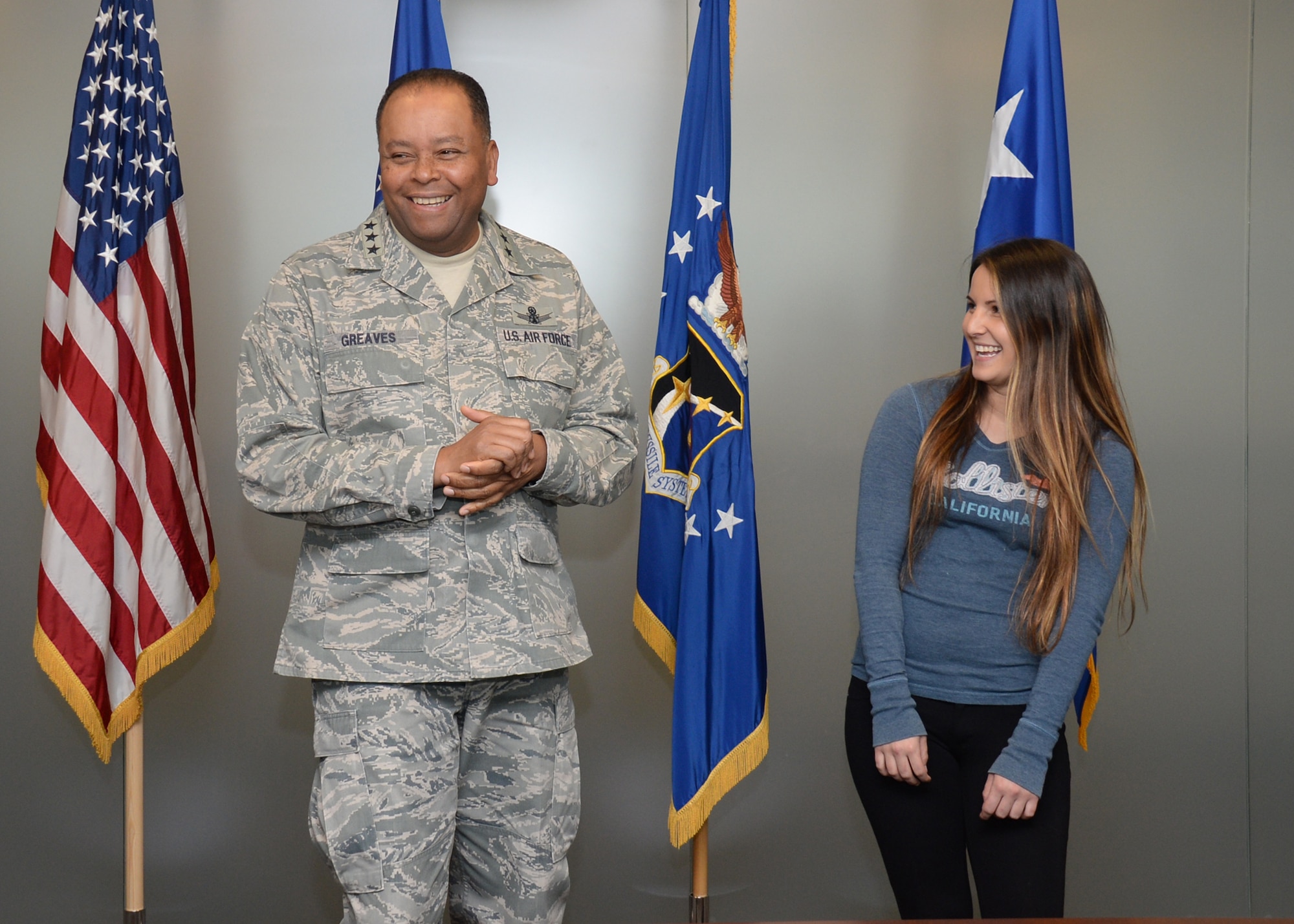 Lt. Gen. Samuel Greaves, Space and Missile Systems Center commander and Air Force program executive officer for space, shares a light moment with Air Force Reserve recruit Jennie Ines prior to beginning an impromptu oath of enlistment ceremony, Jan. 21, 2016. The event transpired as the result of a chance meeting the previous December by the Exchange at Los Angeles Air Force Base in El Segundo, Calif. (U.S. Air Force photo/Van Ha)
