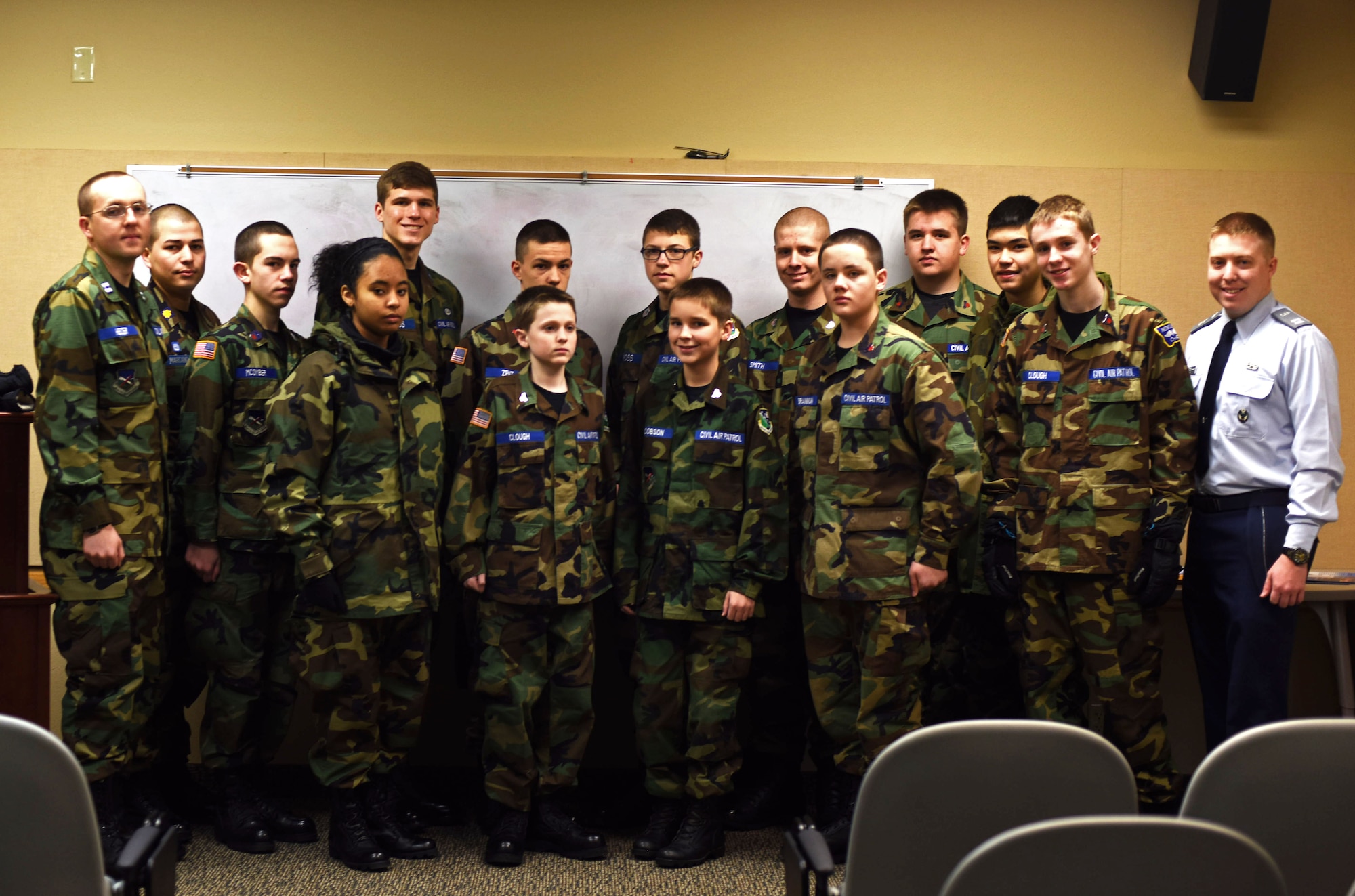 Members of the Civil Air Patrol Malmstrom Composite Squadron pose for a photograph after a pre-flight brief at the Malmstrom Air Force Base 40th Helicopter Squadron building Jan. 23, 2016. After the meeting, members of the CAP squadron had the opportunity to ride in a helicopter for an orientation flight. (U.S. Air Force photo/Airman Collin Schmidt) 