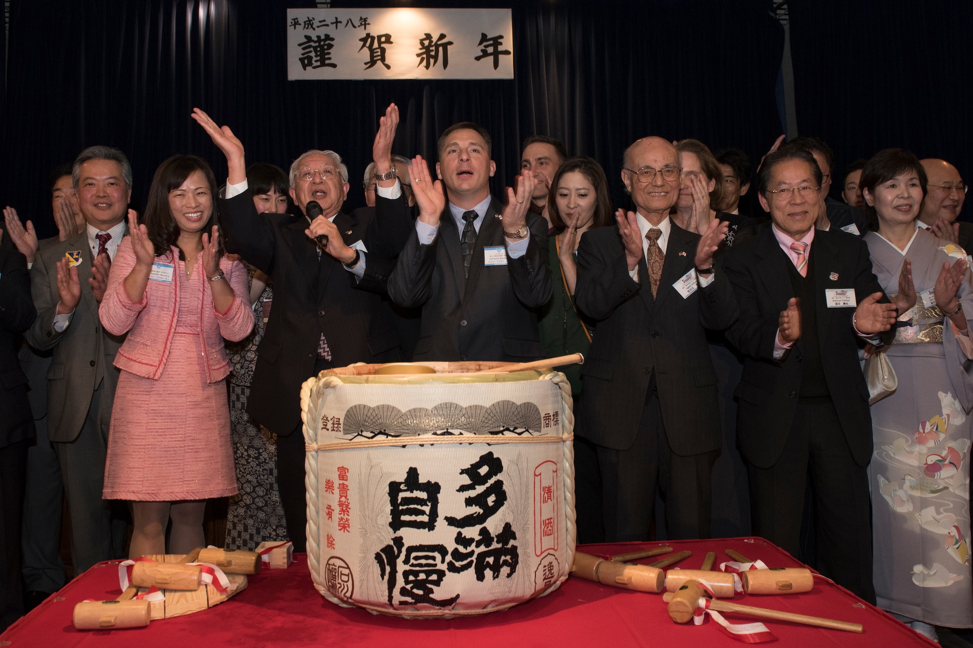 The Akashima-Yokota friendship club and its counterpart the 374th Mission Support Group perform the tejime to close the Joint New Year’s party at Yokota Air Base, Japan, Jan. 23, 2016. The tejime, also called teuchi, is a Japanese custom of ceremonial hand clapping performed at the end of special events. (U.S. Air Force photo by Machiko Imai/Released) 