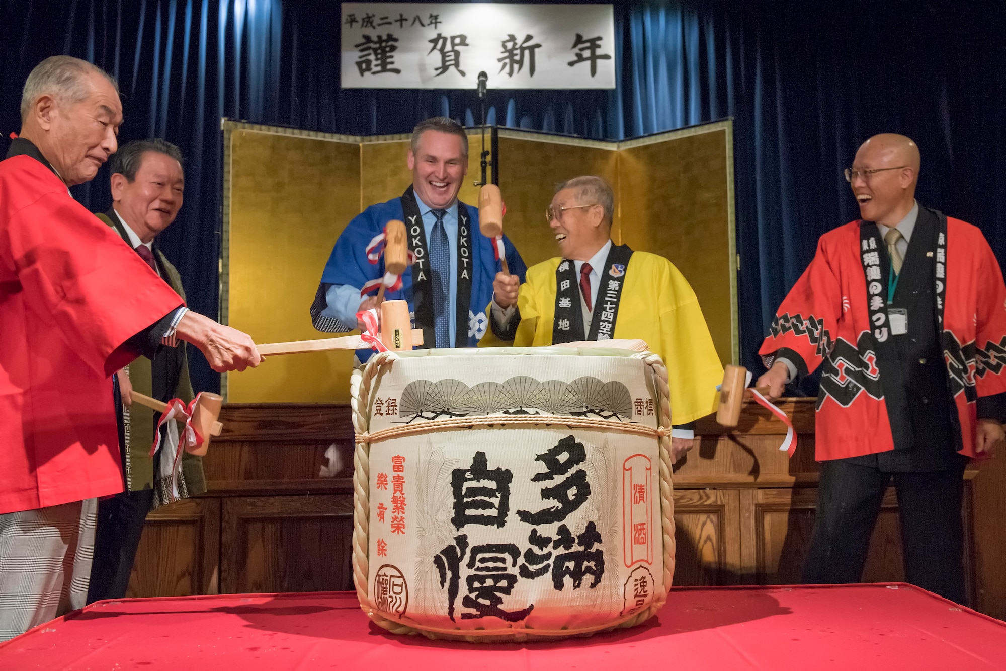 (Center) Col. Douglas DeLaMater, 374th Airlift Wing commander, along with several friendship club presidents participate in a traditional breaking of a sake keg at the Joint New Year’s Party at Yokota Air Base, Japan, Jan. 23, 2016. The seven Yokota friendship clubs hosted this event for members of the communities to help strengthen U.S. and Japanese relations, and to thank local organizations for their support during the year. (U.S. Air Force photo by Machiko Imai/Released) 