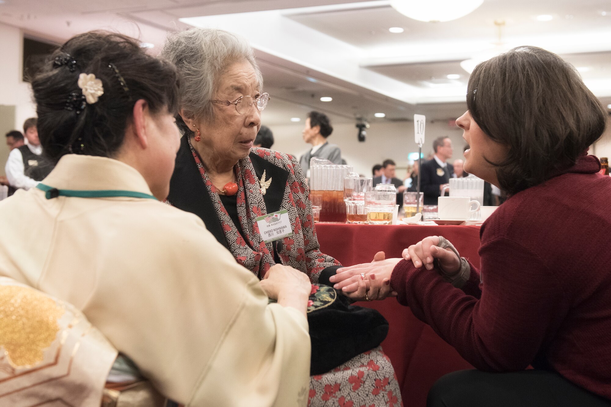 (Right to left) Rebecca Robertson, wife of Col. Sean Robertson, 374th Maintenance Group vice commander, talks to Chieko Nishikawa, a member of Akishima-Yokota Friendship Club, during the Joint New Year’s Party at Yokota Air Base, Japan, Jan. 23, 2016. The seven Yokota friendship clubs, which Mizuho town, Fussa city, Akiruno city, Hamura city, Musashimurayama city, Ome city, and Akishima city, hosted this event for members of the community to help strengthen U.S. and Japanese relations, and to thank local organizations for their support during the year. (U.S. Air Force photo by Machiko Imai/Released)