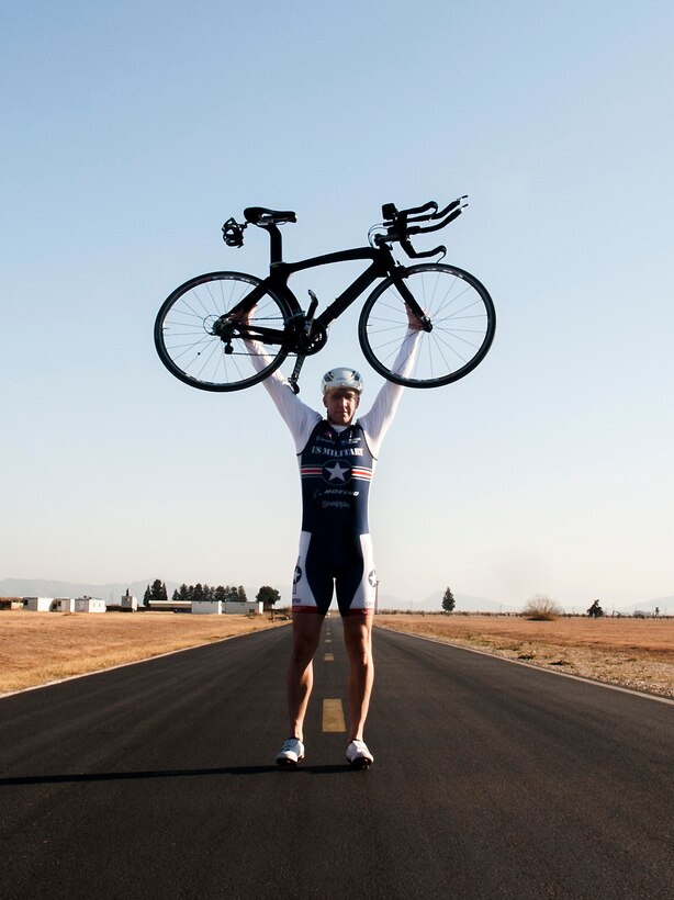 U.S. Air Force Senior Master Sgt. Jason Chiasson, 39th Communications Squadron production superintendent, holds his bike aloft after completing a ride on Dec. 22, 2015, at Incirlik Air Base, Turkey.  Chiasson is a member of the Air Force Cycling Team. (U.S. Air Force photo by Senior Airman Krystal Ardrey/Released)