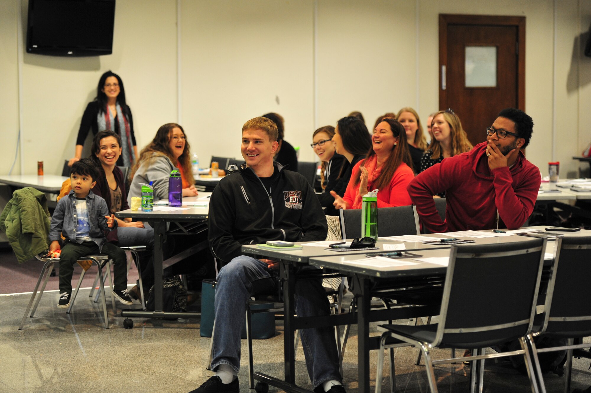 Recently arrived military family members listen to speakers during a new spouse orientation at the Schilling Community Center, Jan. 26, 2016, at Kadena Air Base, Japan. Family members received information from various organizations across Kadena to help them adjust to overseas military living in Japan. (U.S. Air Force photo by Senior Airman Peter Reft)