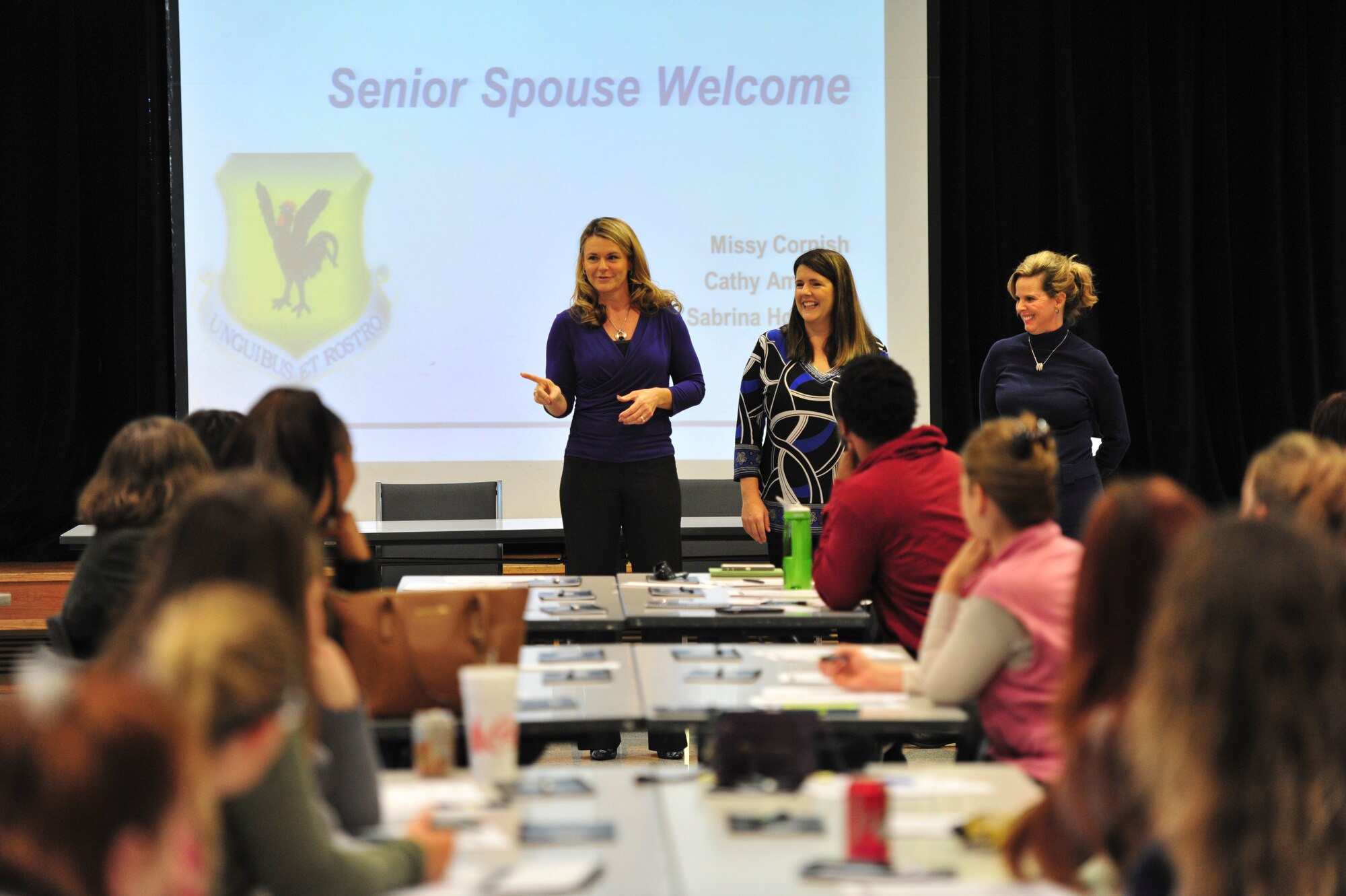 Missy Cornish, Cathy Amrhein and Sabrina Hoffman, senior spouses, speak to family members during a new spouse orientation at the Schilling Community Center, Jan. 26, 2016, at Kadena Air Base, Japan. Groups such as the Airman & Family Readiness Center, Chaplains, Spouses Clubs and the 18th Force Support Squadron participated in the event to assist new spouses with their transition to Kadena and living in Japan. (U.S. Air Force photo by Senior Airman Peter Reft)
