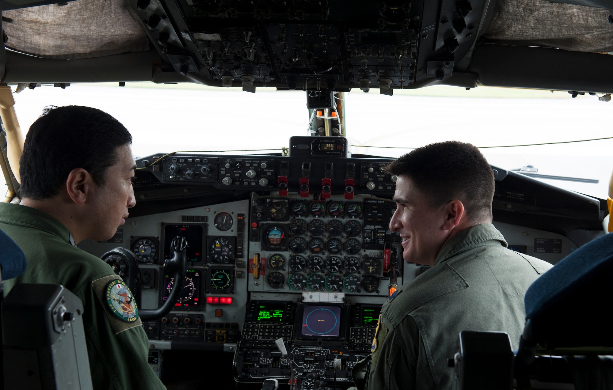 U.S. Air Force Lt. Col. Jonathan Burdick, 909th Air Refueling Squadron commander, shows Japan Air Self Defense Force Lt. Col. Takahiro Seki, 404th ARS commander, the cockpit of the KC-135 Stratotanker Jan. 22, 2016, at Kadena Air Base, Japan. Both commanders were able to talk over their positions as commanders and pilots. (U.S. Air Force photo by Airman 1st Class Lynette M. Rolen) 