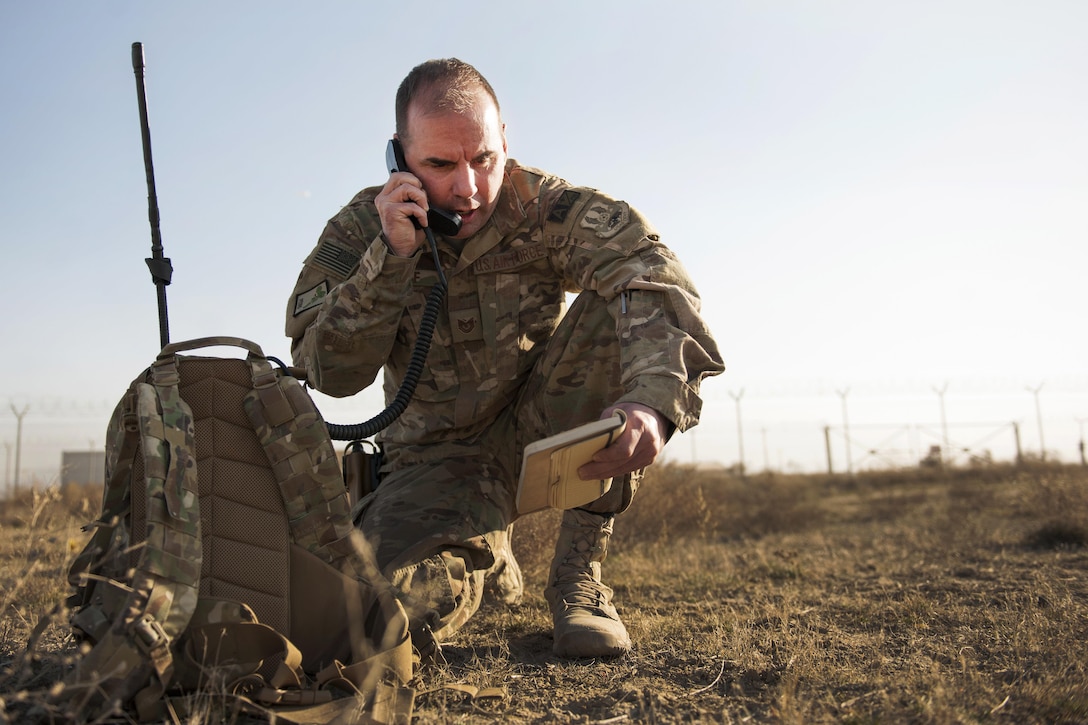 An Air Force airman radios in a 9-Line medevac request during an exercise on Bagram Airfield, Afghanistan, Jan. 23, 2016. The airman is assigned to the 83rd Expeditionary Rescue Squadron. The exercise allowed service members and the Craig Joint Theater Hospital an opportunity to practice their response to real-world emergency scenarios. Air Force photo by Tech. Sgt. Robert Cloys 