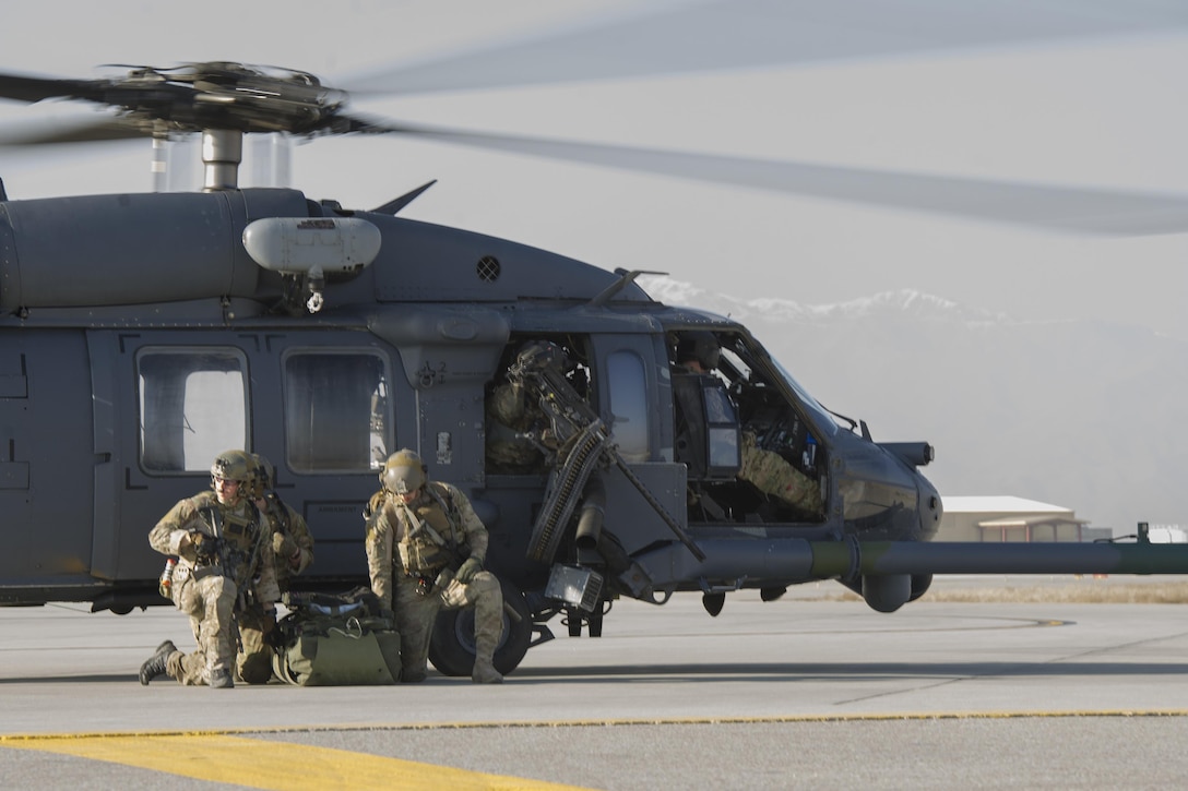 Air Force pararescuemen prepare their gear before moving from a landing zone during an extrication exercise on Bagram Airfield, Afghanistan, Jan. 23, 2016. Air Force photo by Tech. Sgt. Robert Cloys