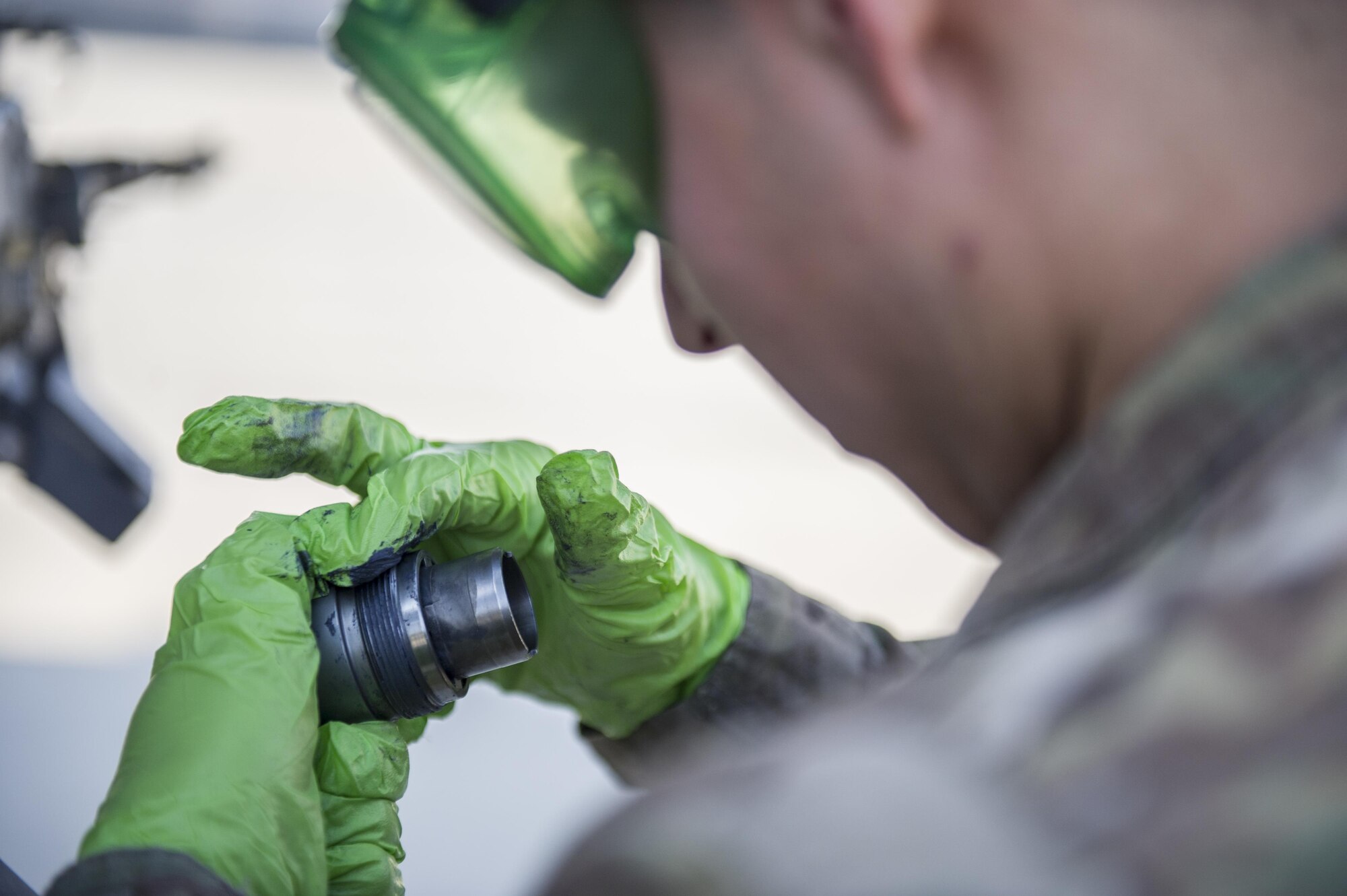 Airman 1st Class Gabriel Rey, 455th Expeditionary Aircraft Maintenance Squadron weapons load crew member, lubricates an impulse cartridge retainer during a 30-day inspection at Bagram Airfield, Afghanistan, Jan. 15, 2016. The weapons team performs a critical role for the close air support mission, ensuring Fighting Falcon pilots have the correct and functional munitions to provide the air cover ground forces need. (U.S. Air Force photo/Tech. Sgt. Robert Cloys)