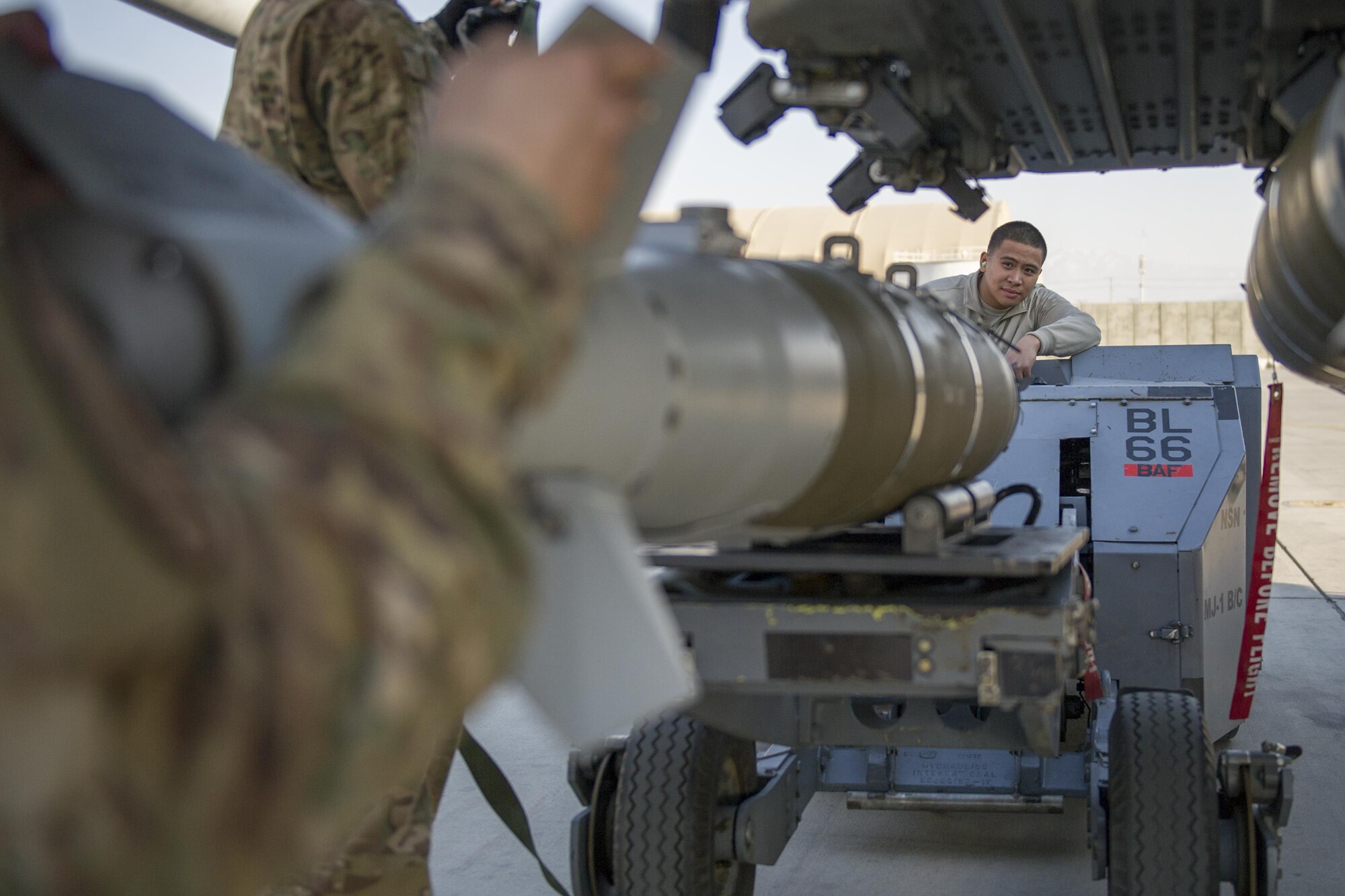 Airman 1st Class Rhaymark Neri, 455th Expeditionary Aircraft Maintenance Squadron weapons load crew member, uses a MJ-1 to load a GBU-54 to an F-16 Fighting Falcon during a 30-day inspection at Bagram Airfield, Afghanistan, Jan. 15, 2016. The weapons team performs a critical role for the close air support mission, ensuring Fighting Falcon pilots have the correct and functional munitions to provide the air cover ground forces need. (U.S. Air Force photo/Tech. Sgt. Robert Cloys)