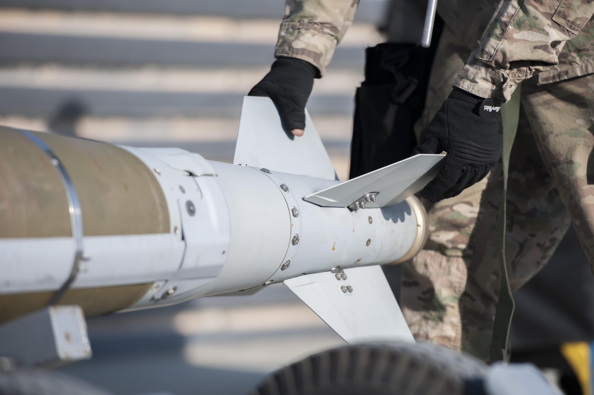 Staff Sgt. Chris White, 455th Expeditionary Aircraft Maintenance Squadron weapons load crew chief, moves a GBU-54 to a bomb stand after downloading it from an F-16 Fighting Falcon at Bagram Airfield, Afghanistan, Jan. 15, 2016. The weapons team performs a critical role for the close air support mission, ensuring Fighting Falcon pilots have the correct and functional munitions to provide the air cover ground forces need. (U.S. Air Force photo/Tech. Sgt. Robert Cloys)