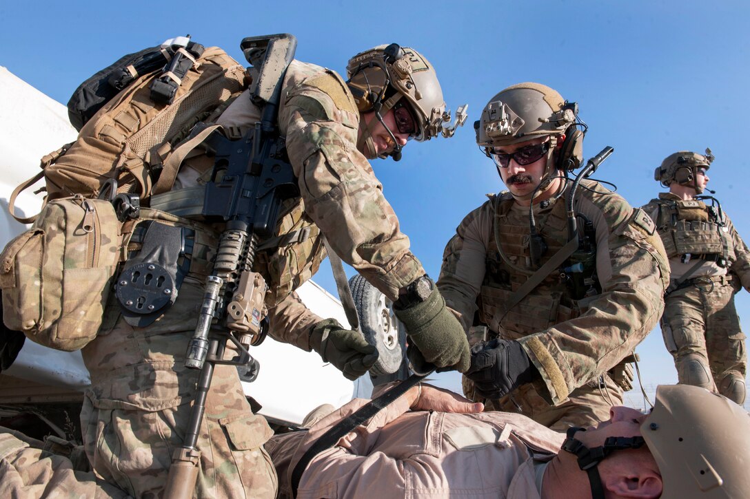 Air Force pararescuemen strap Air Force Brig. Gen. Dave Julazadeh, foreground, to a stretcher as he role-plays a casualty in an extrication exercise on Bagram Airfield, Afghanistan, Jan. 23, 2016. Julazadeh is the commander of the 455th Air Expeditionary Wing. Air Force photo by Tech. Sgt. Robert Cloys