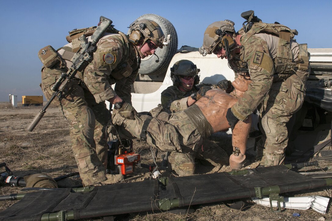 Air Force pararescuemen move a mannequin simulating a casualty to a stretcher during an extrication exercise on Bagram Airfield, Afghanistan, Jan. 23, 2016. Air Force photo by Tech. Sgt. Robert Cloys