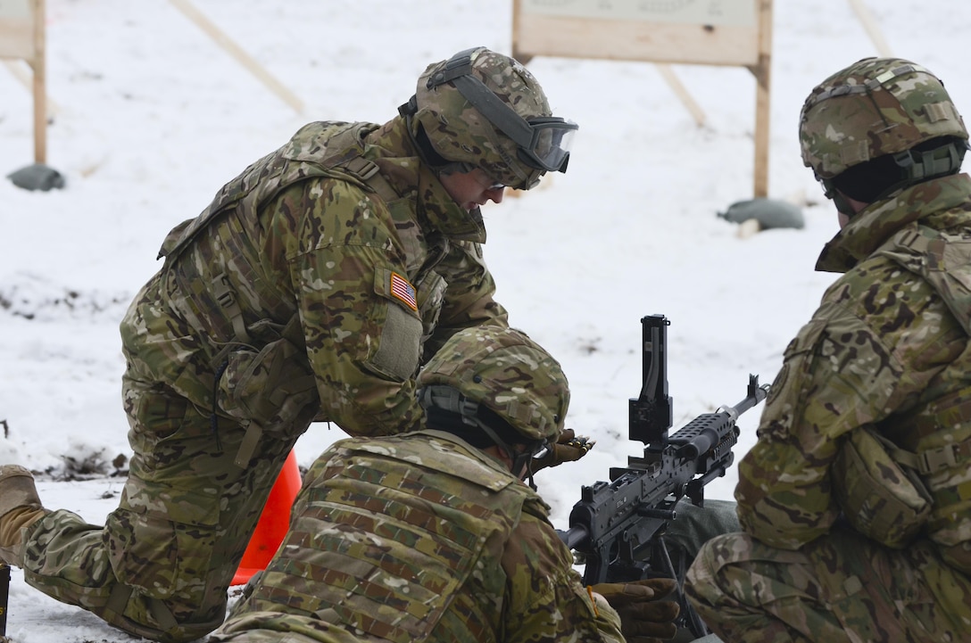 Army Pfc. Collin Sapp, left, loads a belt of ammo into an M240 machine gun during a training exercise at Adazi Training Area in Latvia, Jan. 25, 2016. Sapp is an assistant gunner assigned to 3rd Squadron, 2nd Cavalry Regiment. Army photo by Staff Sgt. Steven Colvin
