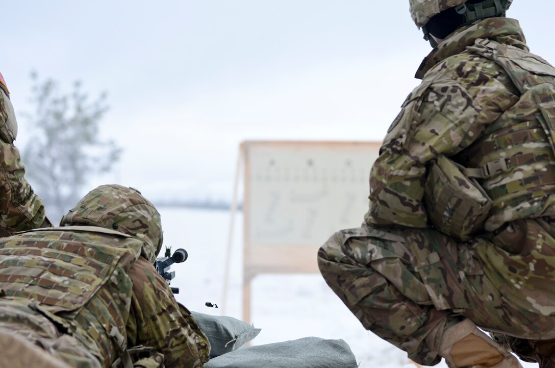 Army Staff Sgt. Andrew Nee, right, coaches a soldier firing an M240 machine gun during a training exercise at Adazi Training Area in Latvia, Jan. 25, 2016. Nee is an engineer squad leader assigned to 3rd Squadron, 2nd Cavalry Regiment. U.S. Army photo by Staff Sgt. Steven Colvin