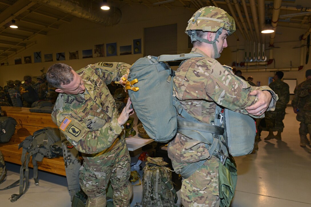 Army Lt. Col. Eric Baus, left, conducts a jumpmaster personnel inspection of Army Chief Warrant Officer 2 Benjamin Holladay’s equipment before an airborne operation on Aviano Air Base, Italy, Jan. 20, 2016. Baus is deputy commander, 173rd Airborne Brigade and Holladay is a paratrooper assigned to the 173rd Airborne Brigade. U.S. Army photo by Davide Dalla Massara