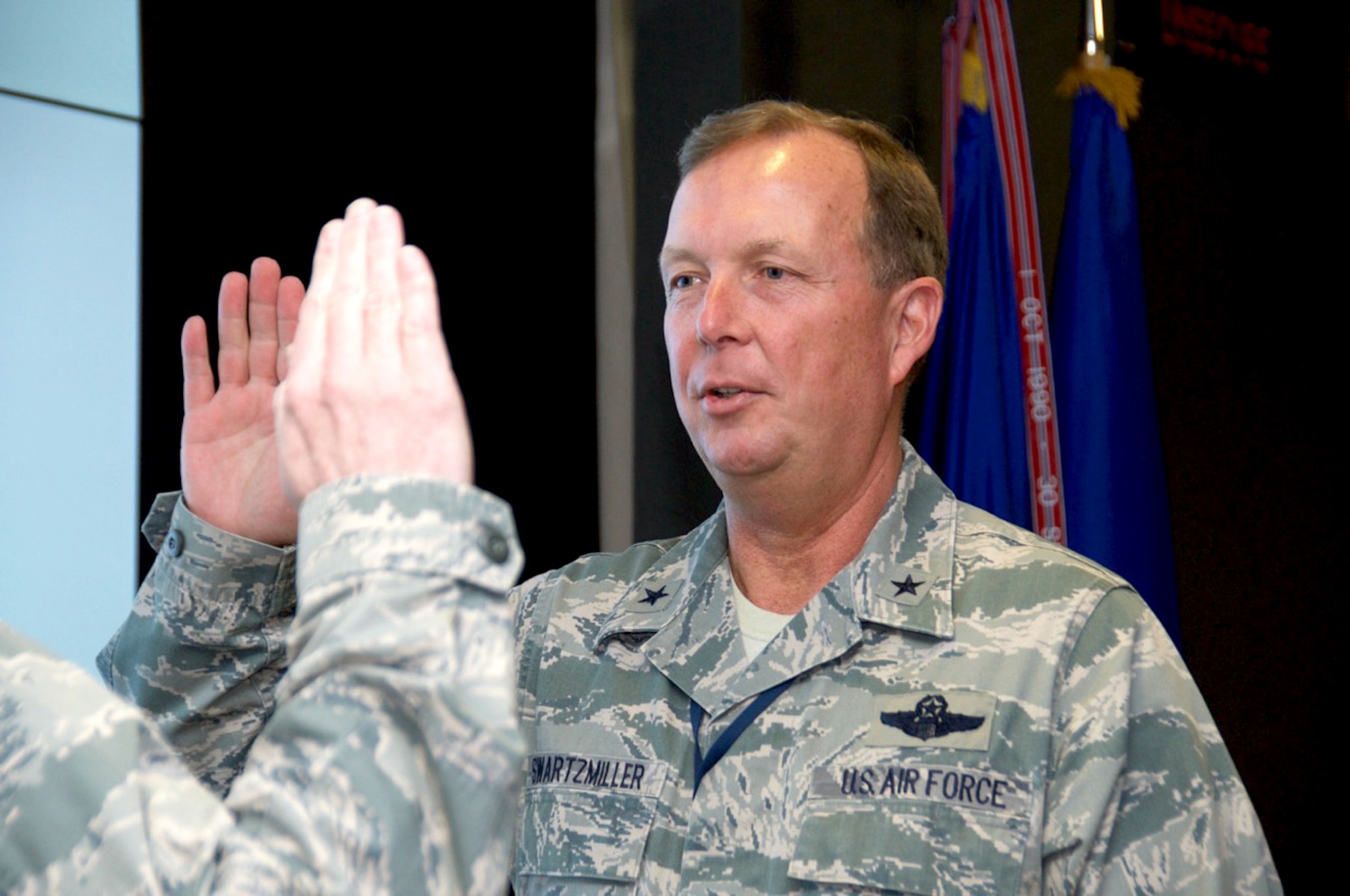 Brig. Gen. Allan Swartzmiller, Air Force Reserve Command Inspector General, Robins Air Force Base, Ga., is sworn in by  Lt. Gen. James Jackson, Chief of Air Force Reserve, Headquarters U.S. Air Force, Washington, D.C., and Commander, Air Force Reserve Command, during a directors meeting Jan. 19. Swartzmiller is responsible for advising the command's leadership on how to optimize resources and enhance mission