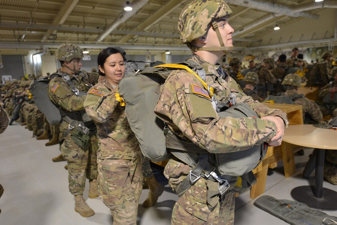 Army 1st Lt. Kristina-Noel Donahue, center, conducts a jumpmaster personnel inspection of Army 1st Lt. Anthony Fosco’s equipment before an airborne operation on Aviano Air Base, Italy, Jan. 20, 2016. Donahue is a jumpmaster assigned to the 54th Brigade Engineer Battalion, 173rd Airborne Brigade and Fosco is a paratrooper assigned to the 173rd Airborne Brigade. U.S. Army photo by Davide Dalla Massara