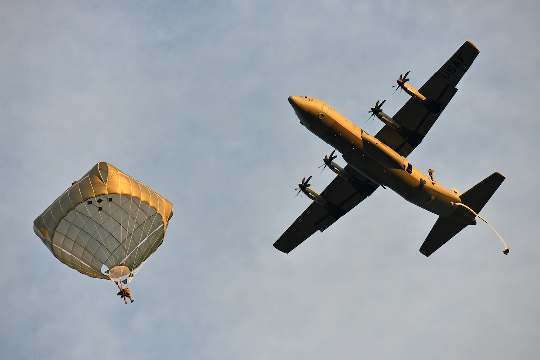 An Army paratrooper descends to the ground from a U.S. Air Force C-130 Hercules aircraft over Juliet drop zone in Pordenone, Italy, Jan. 20, 2016. U.S. Army photo by Davide Dalla Massara 