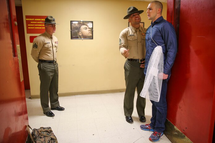 Staff Sergeant Joshua M. Cardona and Sgt. Daniel E. Elizarraraz, drill instructors, Receiving Company, Support Battalion, instruct a recruit to say the proper greeting of the day when a Marine passes him during receiving at Marine Corps Recruit Depot San Diego, Jan. 25. Recruits are required to be respectful to any Marine they come in contact with to practice customs and courtesies. Annually, more than 17,000 males recruited from the Western Recruiting Region are trained at MCRD San Diego. Alpha Company is scheduled to graduate April 22.