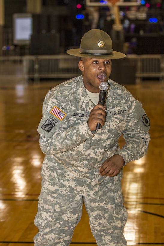 Army Reserve drill sergeant Staff Sgt. Brian Johnson, Task Force Marshall, 108th Training Command (IET), rallies the troops during a skills competition at Fan Fest during the 2015 CIAA basketball tournament held annually in Charlotte, N.C. Johnson is part of a team of Soldiers selected to showcase the advantages and opportunities of military service by way of the Army Reserve at the event. (U.S. Army Photo by Sgt. 1st Class Brian Hamilton)