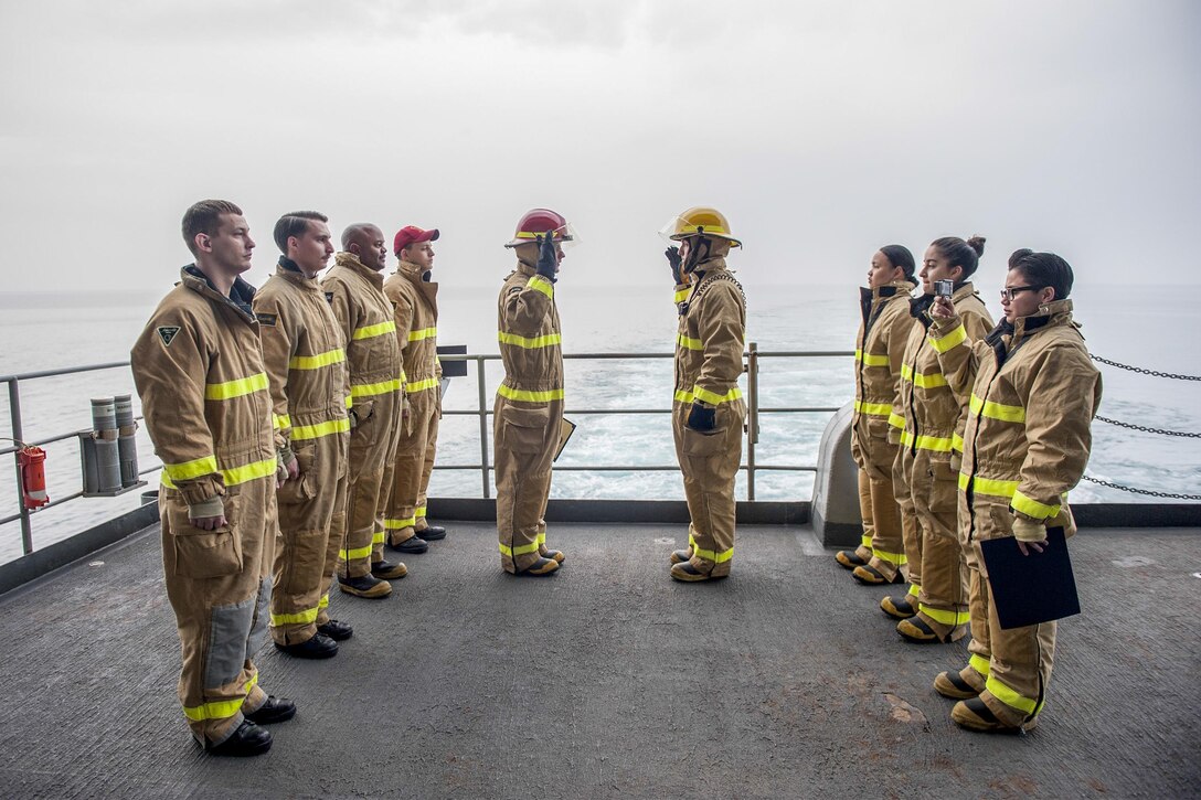 U.S. sailors participate in a re-enlistment ceremony aboard the aircraft carrier USS Harry S. Truman in the Arabian Gulf, Jan. 23, 2016. The Truman is deployed to support Operation Inherent Resolve and other security cooperation efforts in the U.S. 5th Fleet area of operations. U.S. Navy photo by Petty Officer Seaman Lindsay A. Preston