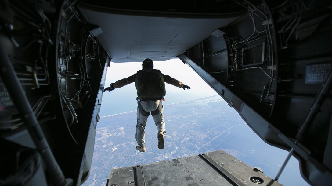 A Marine with U.S. Marine Corps Forces, Special Operations Command jumps out of the back of an MV-22B Osprey at a height of 13,000 feet with Marine Medium Tiltrotor Squadron 365 at Marine Corps Air Station New River, North Carolina, Jan. 21, 2016. The squadron supported Marine Raiders by conducting high altitude low opening jumps, which are jumps at a height of around 13,000 feet, as well as static line jumps, which are jumps at a height of around 4,000 feet, to allow MARSOC Marines to train for future operations.