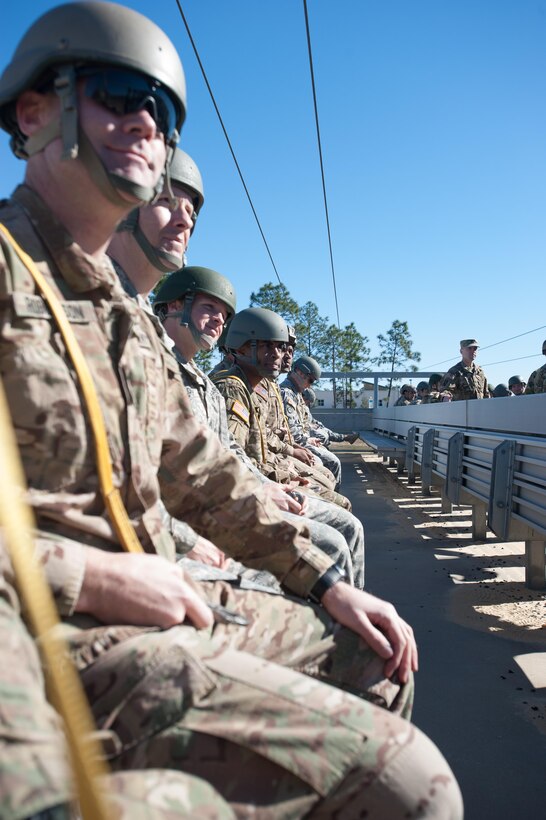 Green Berets and soldiers listen to instructions during safety training before participating in a static-line parachute jump on Eglin Air Force Base, Fla., Jan 13, 2016. The Green Berets and soldiers are assigned to the 7th Special Forces Group, Airborne. The training was conducted to maintain their proficiency at airborne operations. Army photo by Staff Sgt. William Waller