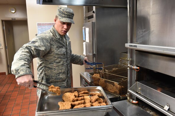 Senior Airman Kyle Slaughter, a food services specialist with the 910th Force Support Squadron, prepares country fried steak for lunch here, Jan. 10, 2016. The Force Support Squadron serves five meals for approximately 1300 airmen during unit training assembly weekends. (U.S. Air Force photo/ Tech. Sgt. Rick Lisum)