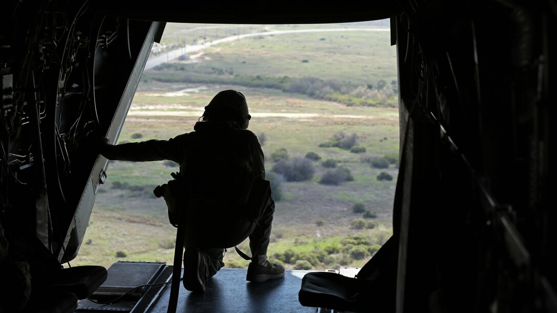 Cpl. Joshua Payne, a crew chief with Marine Medium Tiltrotor Squadron 161 and a Spring, Texas, native, guides the pilots of an MV-22B Osprey to an unprepared field during casualty-evacuation training at Marine Corps Base Camp Pendleton, California, Jan. 20. Casualty-evacuation training prepares the Marines to land in a combat zone, pick up injured Marines and transport them to a safe area.