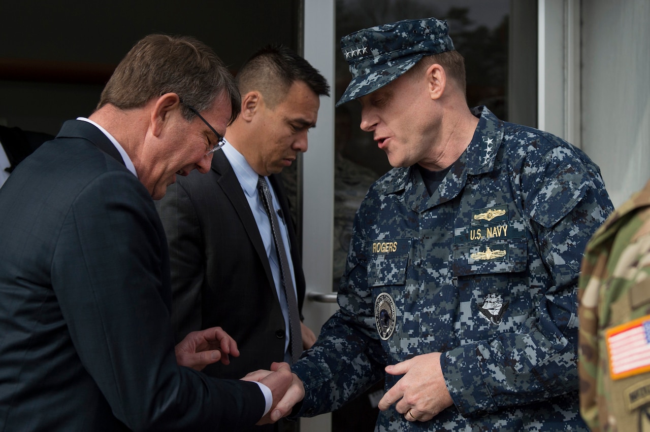 U.S. Cyber Command Commander Adm. Michael S. Rogers presents a challenge coin to Defense Secretary Ash Carter after Carter’s visit to Cybercom headquarters at Fort Meade, Md., Jan. 27, 2016. DoD photo by Air Force Senior Master Sgt. Adrian Cadiz