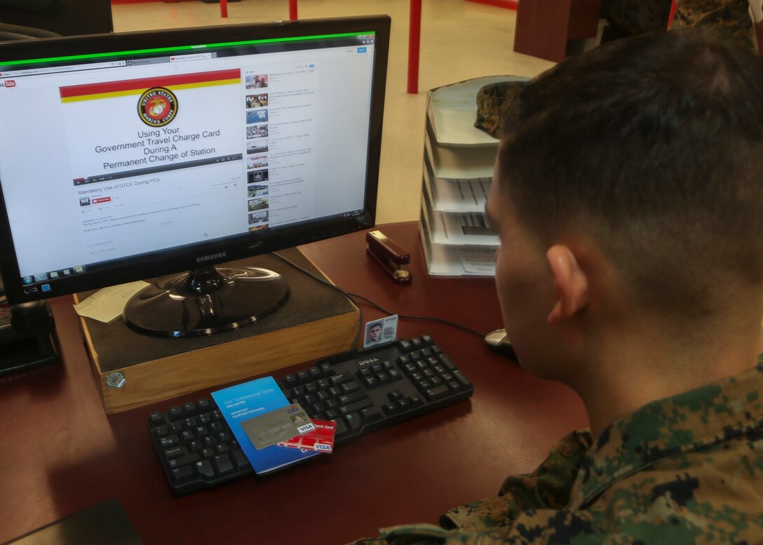 A Marine watches a YouTube video describing the details of Marine administrative message 001/16, which states that all permanent change of station travel expenses will now be paid using the government travel charge card. This change is expected to make travel more efficient and cost effective and to protect Marines from being charged interest on their personal accounts. For more information, watch the video at https://youtu.be/V7WMkMVX8GQ or contact your unit agency program coordinator. (U.S. Marine Corps photo by Cpl. Michelle Reif/Released.)