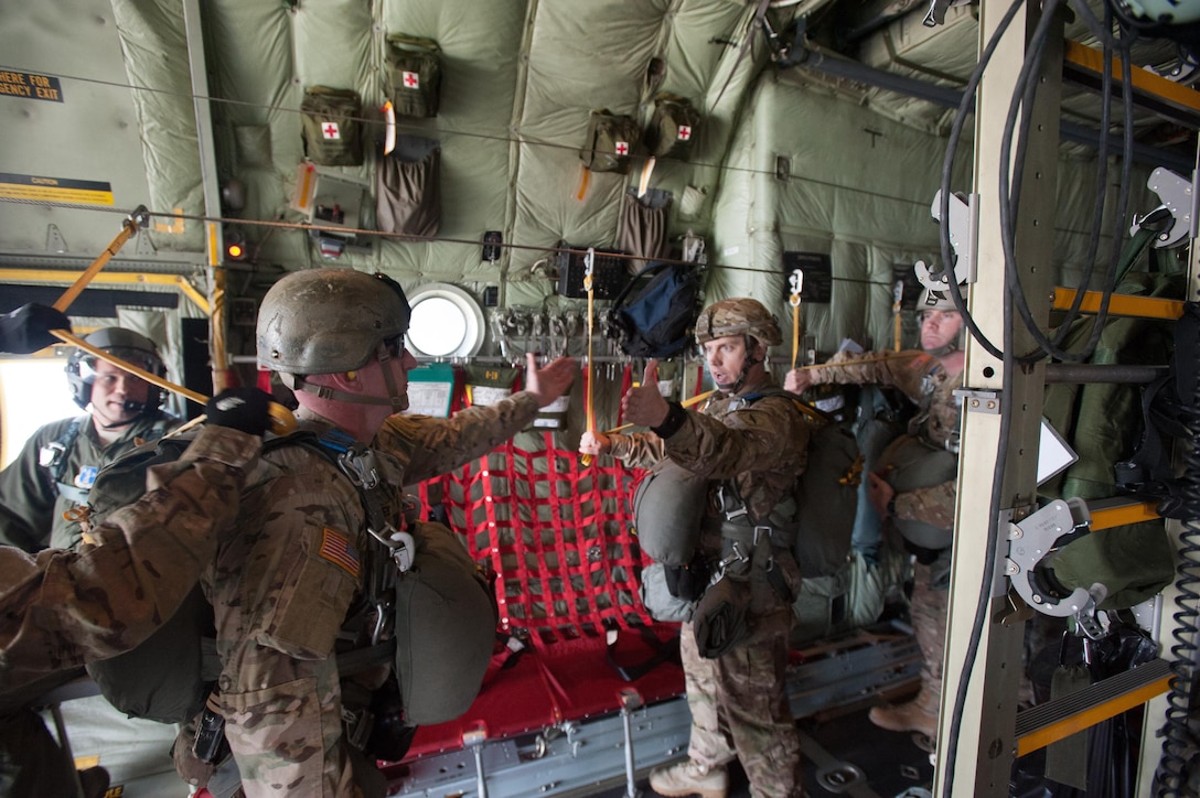 An Army jumpmaster, left, receives the, “all OK jumpmaster," from a paratrooper, signaling each soldier is prepared to conduct a static-line parachute jump over a drop zone on Eglin Air Force Base, Fla., Jan 13, 2016. Army photo by Staff Sgt. William Waller