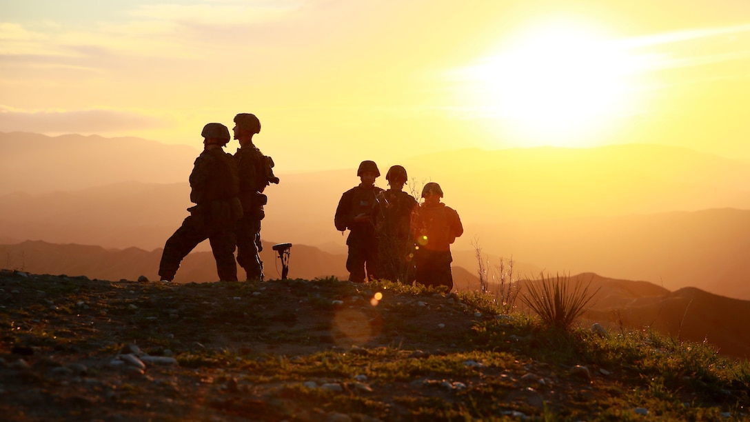 Marines look over the hill tops at their targets as the sun sets at Marine Corps Base Camp Pendleton, California, Jan. 13, 2016. The Marines are a mix of Joint Tactical Attack Controllers and Joint Fire Observers who are responsible for directing fires of artillery and aircraft. The Marines are with 1st Air Naval Gunfire Liaison Company, I Marine Expeditionary Force.