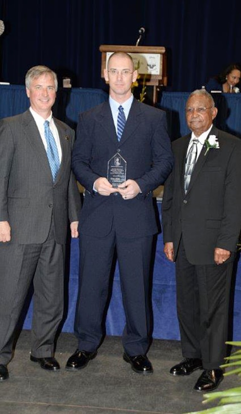 Master Sgt. William Tolleson (center), procurement chief, Contracts Department, Marine Corps Logistics Command, receives the 2016 Dr. Martin Luther King, Jr., Dream Award at the Albany James H. Gray Sr. Civic Center for the 21st annual King Day Celebration to pay tribute to the life and legacy of Dr. Martin Luther King, Jr., noted civil rights leader, Jan. 19. The award is presented by Ken Hodges (left) and Billie Robinson (right), both co-chairmen of the King Day Celebration Committee.  