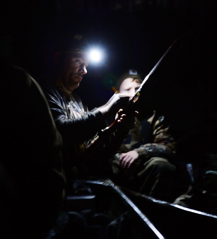 Gunnery Sgt. David A. Kelley, assault amphibious vehicle technician, Marine Corps Systems Command, shows a young duck hunter how to properly load a shotgun during Marine Corps Logistics Base Albany’s annual Youth Duck Hunt, Jan. 16.