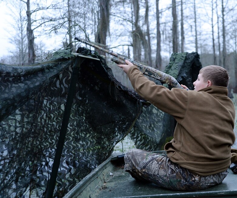 A young duck hunter aims at a flock of duck flying toward him during Marine Corps Logistics Base Albany’s annual Youth Duck Hunt, Jan. 16.