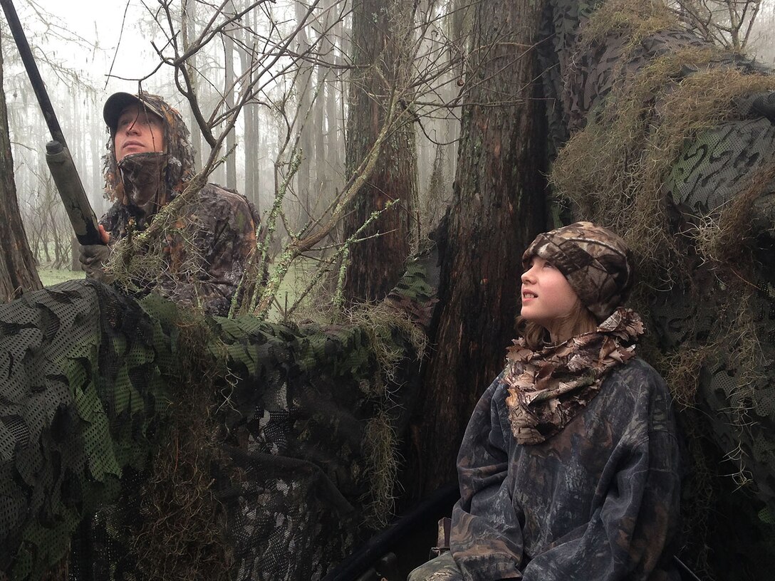 1st Sgt. Marshall Gregg, company first sergeant, Headquarters Company East, Marine Corps Logistics Command, and a young duck hunter waits patiently for ducks to fly into range during Marine Corps Logistics Base Albany’s annual Youth Duck Hunt, Jan. 16.