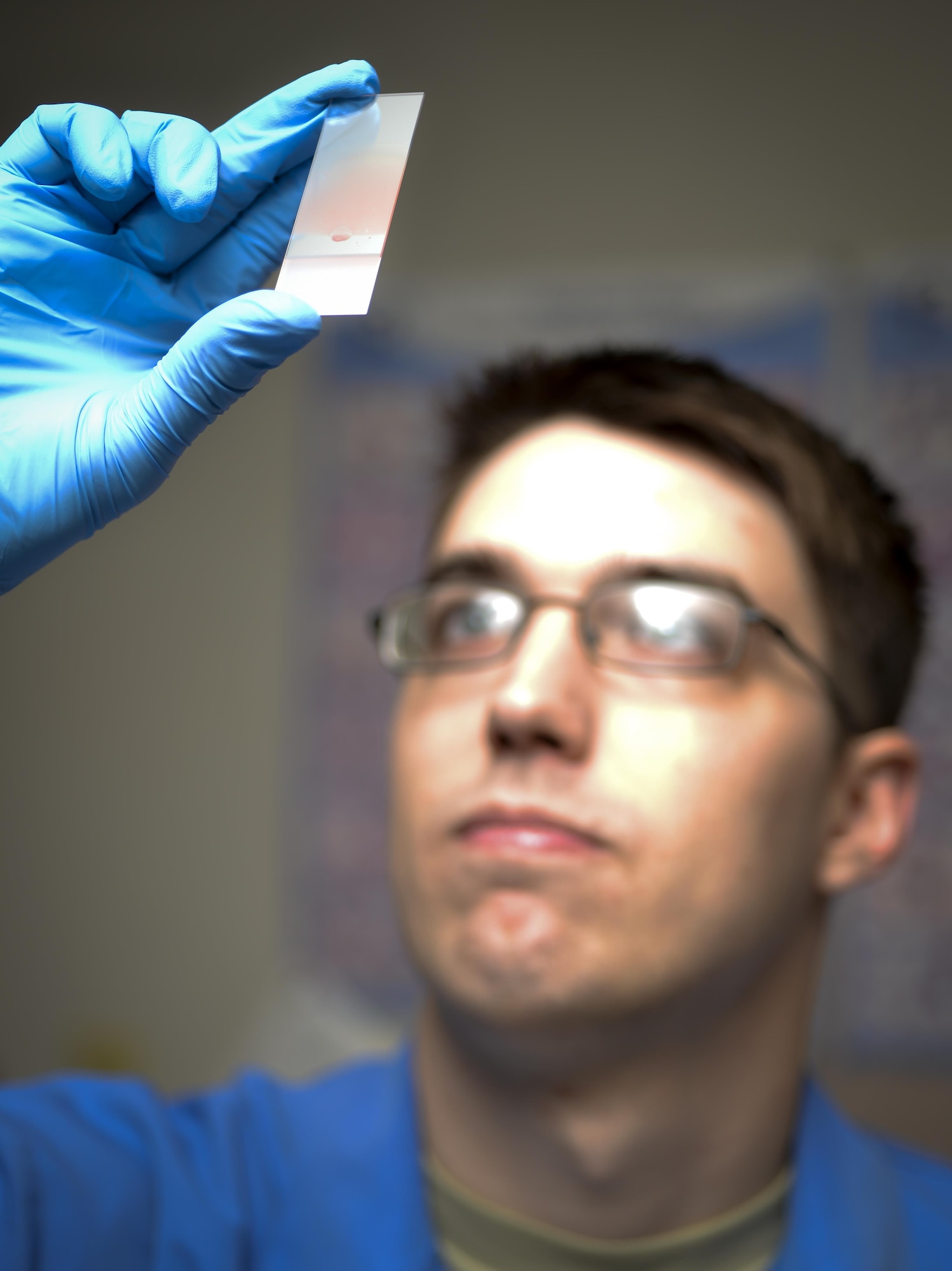 Senior Airman Josef Ansorge, 2nd Medical Support Squadron laboratory technician, visually inspects a blood smear slide at Barksdale Air Force Base, La., Jan. 26, 2016. He performed the visual inspections to provide doctors with information used in the diagnosis of a variety of health conditions.  (U.S. Air Force photo/Airman 1st Class Mozer O. Da Cunha)