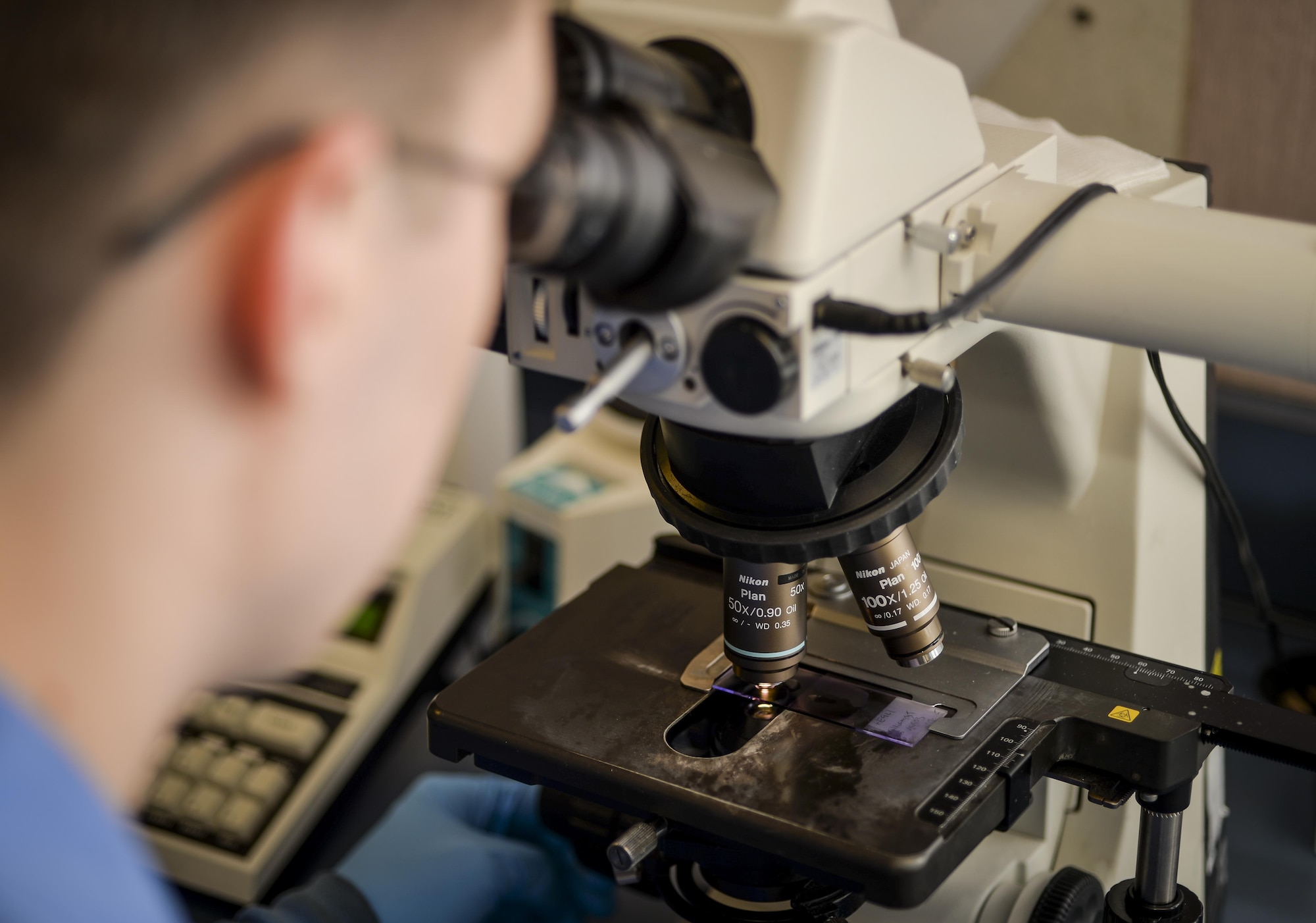 Senior Airman Josef Ansorge, 2nd Medical Support Squadron laboratory technician, uses a microscope to analyze a blood smear slide at Barksdale Air Force Base, La., Jan. 26, 2016. Microscopes used by technicians are flexible and provide multiple levels of magnification assisting in the screening of a variety of different specimens. (U.S. Air Force photo/Airman 1st Class Mozer O. Da Cunha)