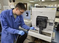 Senior Airman Josef Ansorge, 2nd Medical Support Squadron laboratory technician, removes a blood sample from a complete blood count analyzer at Barksdale Air Force Base, La., Jan. 26, 2016. Complete blood count analyzers detect abnormalities in blood samples, and if specimens are flagged by the machine, additional visual inspections are required by a laboratory technician. (U.S. Air Force photo/Airman 1st Class Mozer O. Da Cunha)