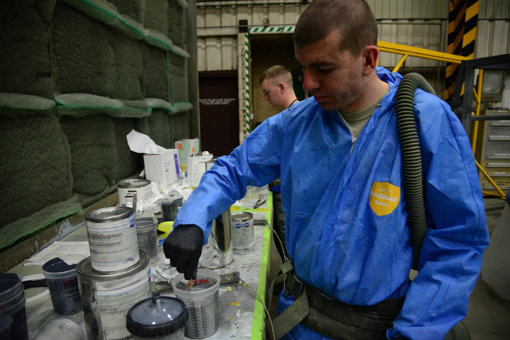 Senior Airman Matthew Cook, 51st Maintenance Squadron aircraft structural maintainer, mixes a container of advanced protective paint at Osan Air Base, Republic of Korea, Jan. 6, 2016. The paint is used to touch up scratches and chips in existing coating and prevents corrosion from developing in the metal. (U.S. Air Force photo by Staff Sgt. Amber Grimm/Released)