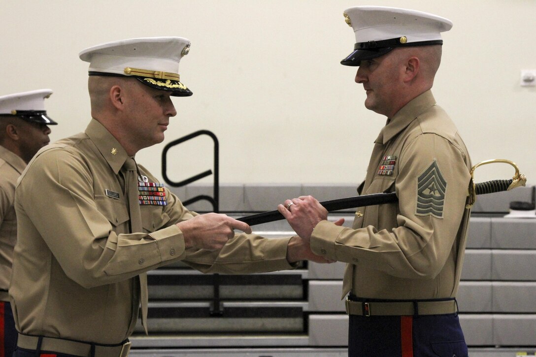Sgt. Maj. Jason A. Politte (right), the incoming enlisted leader of Marine Corps Recruiting Station Orange County, receives the sword of office from Maj. James Dollard, his commanding officer, during a relief and appointment ceremony in Seal Beach, Calif. Jan. 15, 2016. During the ceremony, Sgt. Maj. Spencer J. Beacham, from Dothan, Ala., was awarded a Meritorious Service Medal and relinquished duties to Politte. 