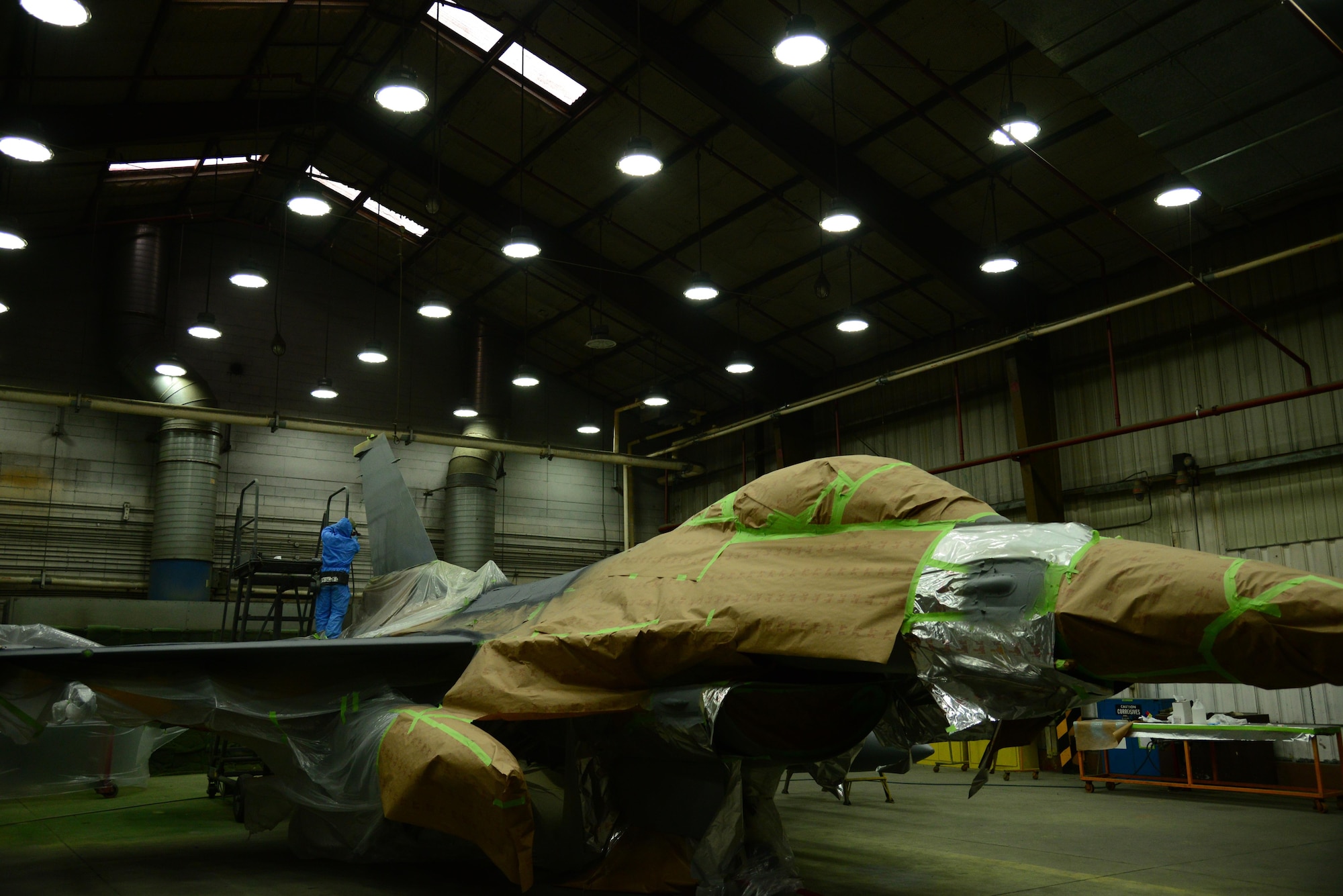 A 51st Maintenance Squadron aircraft structural maintainer, applies a layer of advanced protective paint to the tail of an F-16 Fighting Falcon at Osan Air Base, Republic of Korea, Jan. 6, 2016. Every 10 years aircraft are repainted to prevent metal corrosion. (U.S. Air Force photo/Staff Sgt. Amber Grimm)(Released)