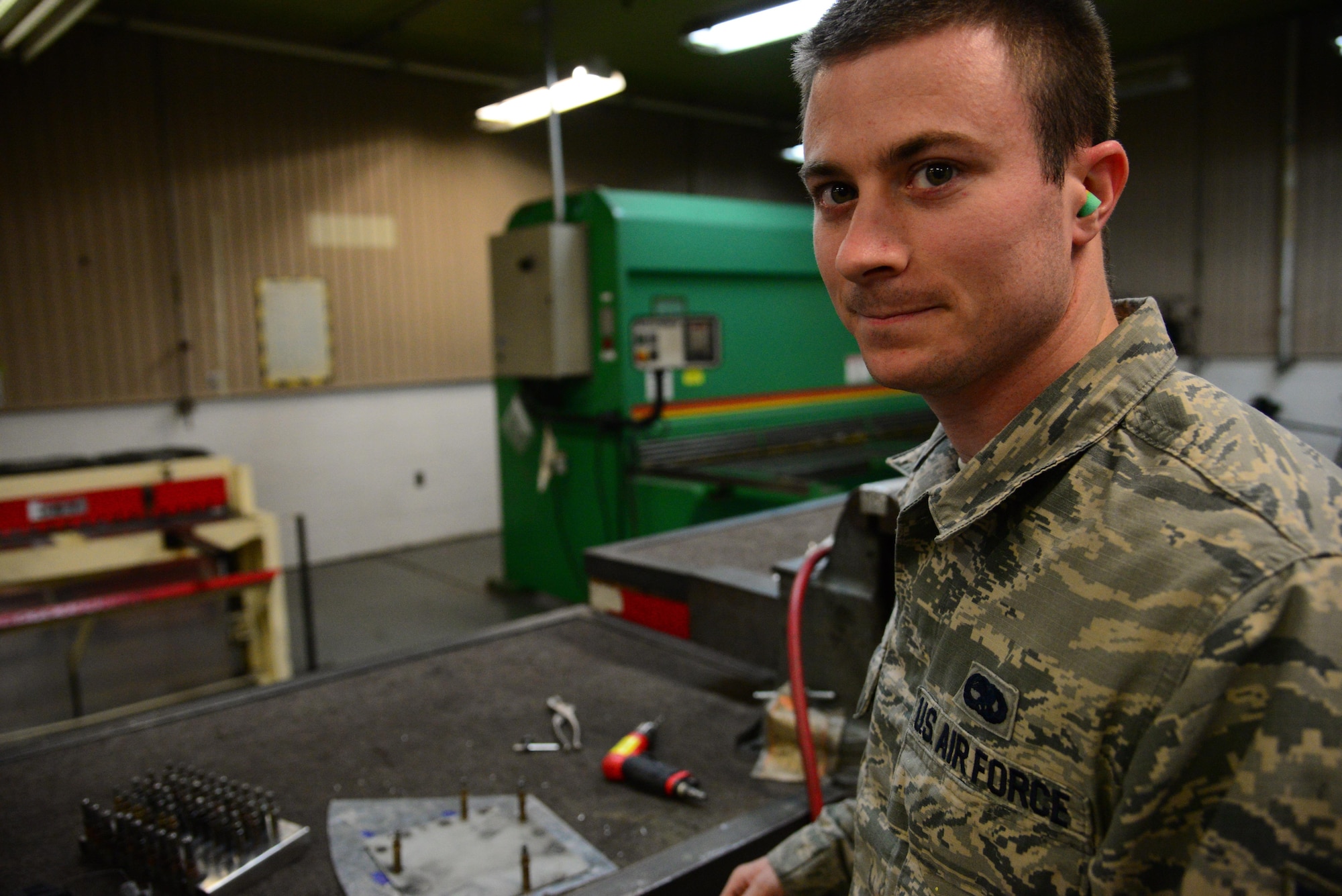 Senior Airman Jon Weiglein, 51st Maintenance Squadron aircraft structural journeyman, prepares to demonstrate drilling techniques at Osan Air Base, Republic of Korea, Jan. 12, 2016. Aircraft structural maintenance specialists are tasked with preserving the structural integrity of operational aircraft on base. (U.S. Air Force photo by Staff Sgt. Amber Grimm/Released)