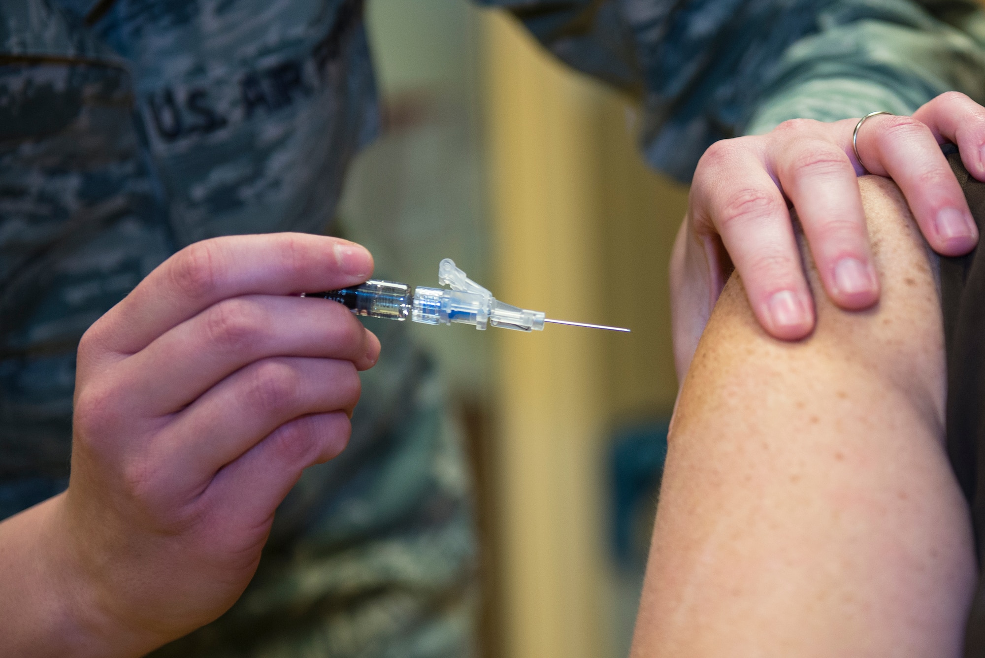 U.S. Air Force Staff Sgt. Chelsea Jones, 23d Medical Operations Squadron immunization back-up technician, prepares to give a patient  a flu shot Jan. 21, 2016, at Moody Air Force Base, Ga. The clinic provides immunizations while also educating and counseling patients on vaccination practices, policies and their life-saving importance. (U.S. Air Force photo by Airman 1st Class Greg Nash/Released) 