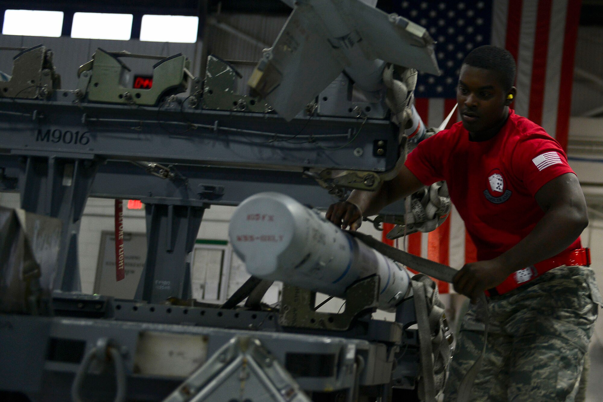 U.S. Air Force Senior Airman Chelloe Hamilton, 20th Aircraft Maintenance Squadron, 77th Aircraft Maintenance Unit weapons load crew member, prepares to transport an AIM-9X training munition from a BRU-57 smart bomb rack during a Load Crew of the Year competition at Shaw Air Force Base, S.C., Jan. 22, 2016. The competition tests the load crew’s ability to quickly, safely, and efficiently load munitions onto an F-16CM Fighting Falcon. (U.S. Air Force photo by Airman 1st Class Christopher Maldonado)