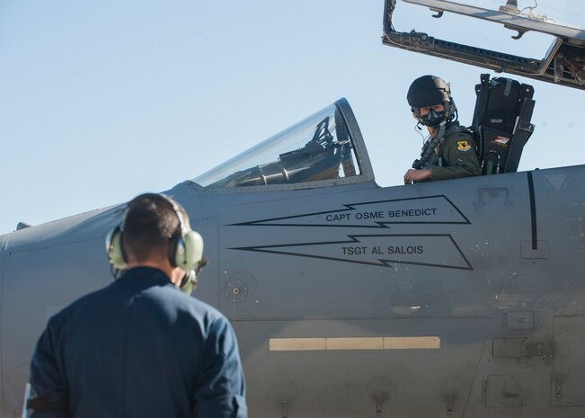 A pilot from the 104th Fighter Wing, 131st Fighter Squadron, Barnes Air National Guard Base, Mass., waits for instruction from his crew chief in preparation for take-off during Red Flag 16-1 Jan. 26, 2016, at Nellis AFB. Flying units from around the globe deploy to Nellis AFB to participate in Red Flag, where it is held four times a year and organized by the 414th Combat Training Squadron. (U.S. Air Force photo by Senior Airman Jake Carter)