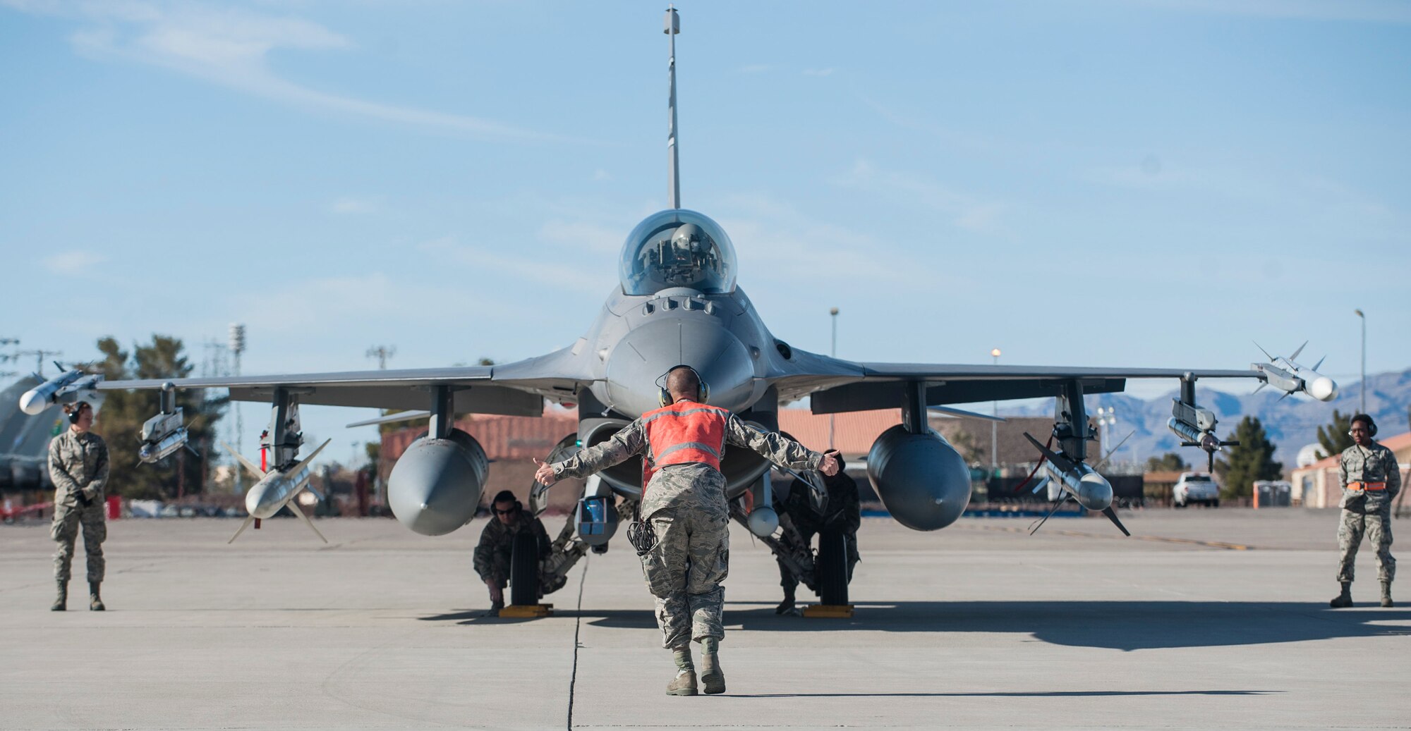 Crew members from the 157th Fighter Wing, McEntire Joint National Guard Base, S.C., conduct pre-flight checks on an F-16CJ during Red Flag 16-1 at Nellis Air Force Base, Nev., Jan. 25, 2016. All four branches of the U.S. military and air forces from allied nations participate in Red Flag. The training is conducted to familiarize forces to work together in future operations. (U.S. Air Force photo by Senior Airman Jake Carter)