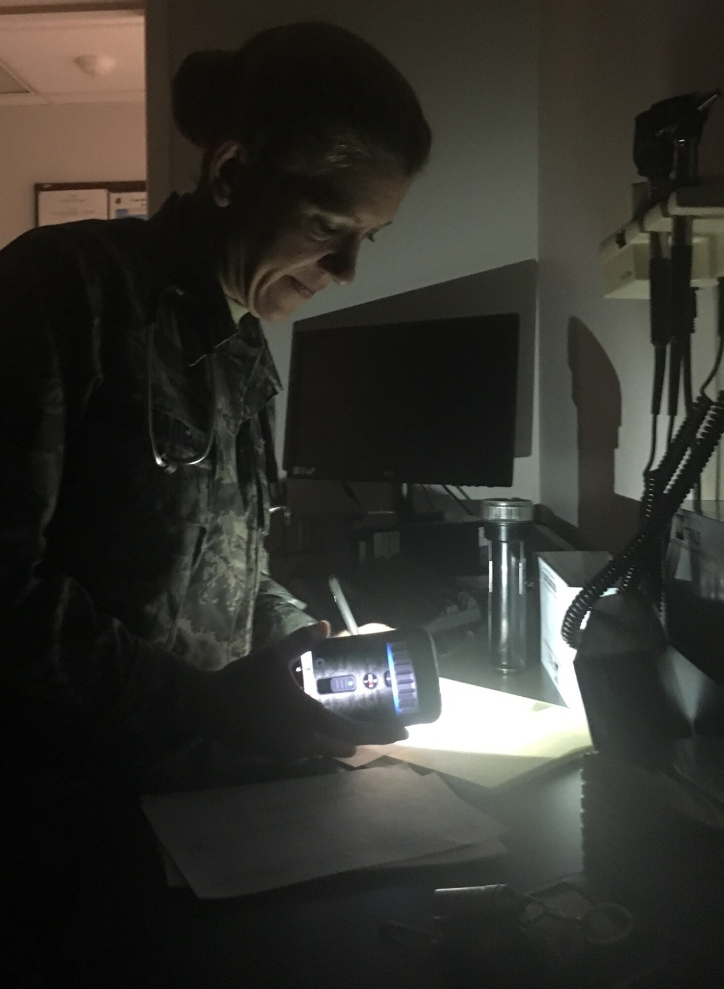 Capt. Kristina Zuccarelli, 4th Medical Group provider, continues to take care of patients during a power outage, Jan. 26, 2016, at Seymour Johnson Air Force Base, North Carolina. Zuccarelli and other 4th MDG medical professionals are committed to providing the best possible care, even when the lights are out. (Courtesy photo)